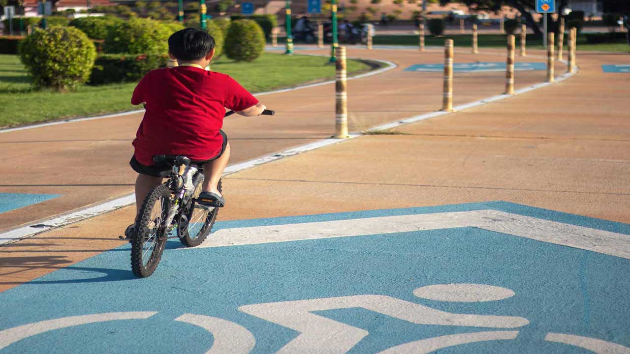 boy riding bike no helmet