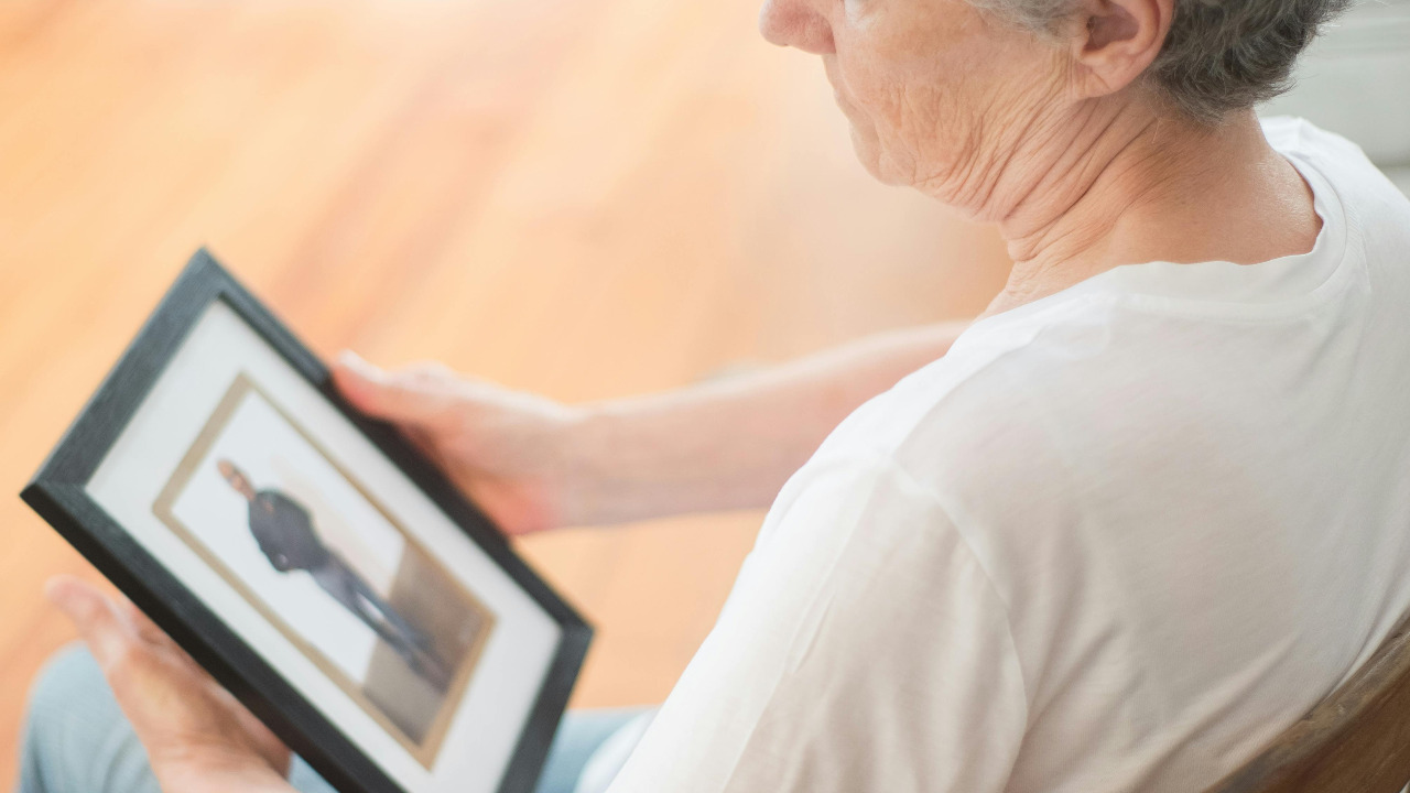 woman looking at framed picture