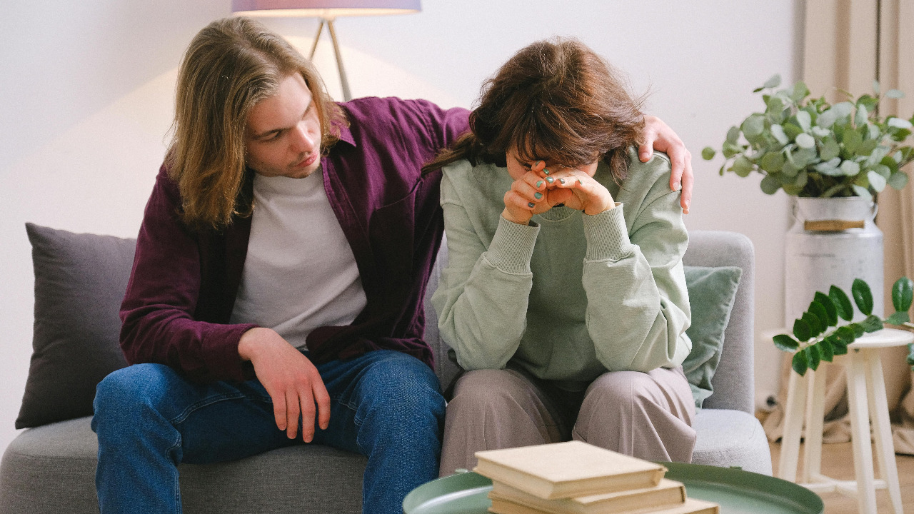 man comforting crying woman