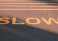 slow sign painted on road