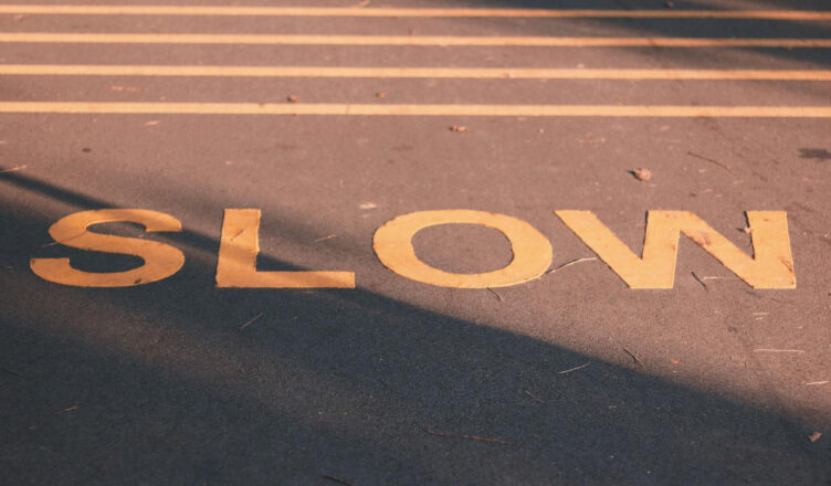 slow sign painted on road