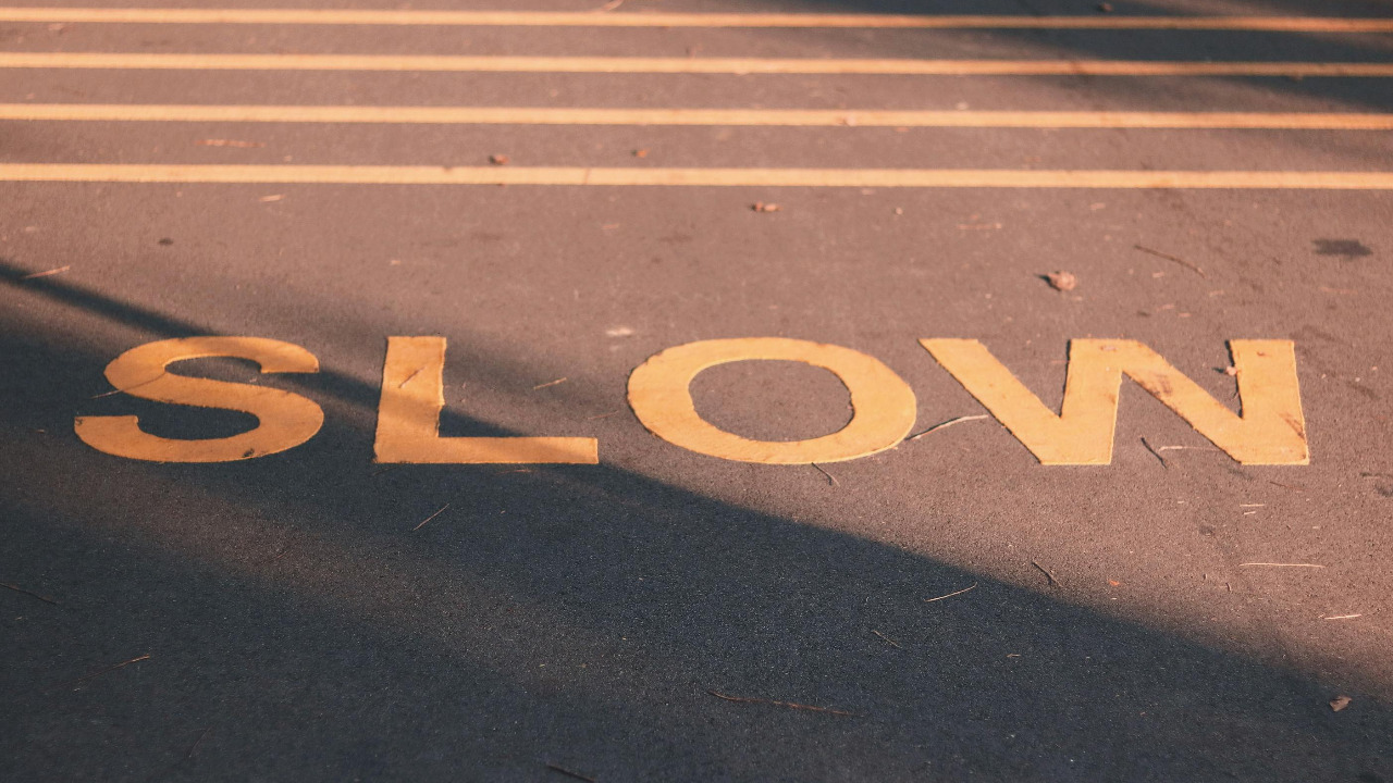 slow sign painted on road