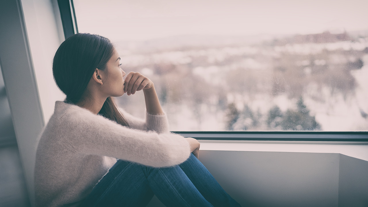 woman looking out the window