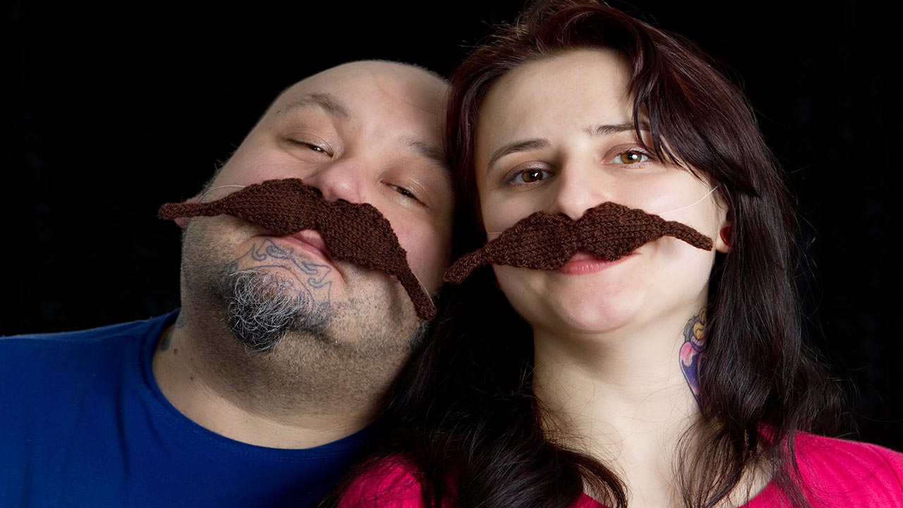 couple wearing fake mustaches