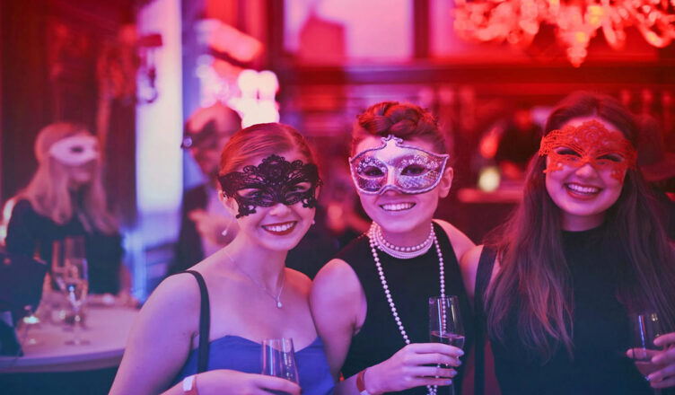 trio of women with masquerade masks