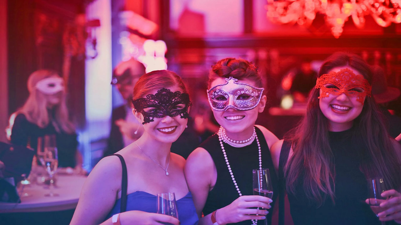 trio of women with masquerade masks